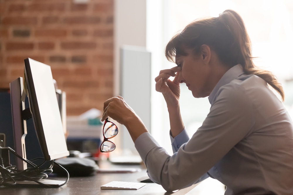 Woman at Desk Suffering From Dry Eye